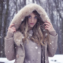 Portrait of young woman wearing warm clothing during winter