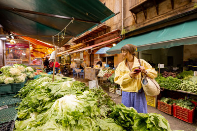 Rear view of man standing in market