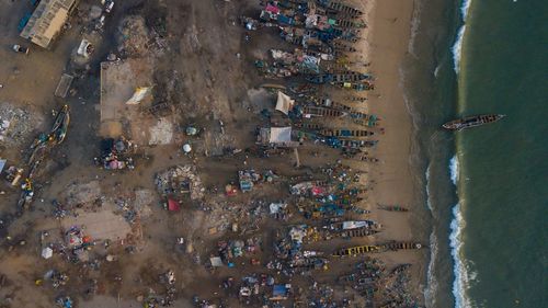 High angle view of people on beach by buildings in city