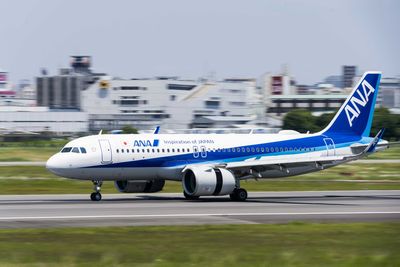 Airplane on airport runway against sky