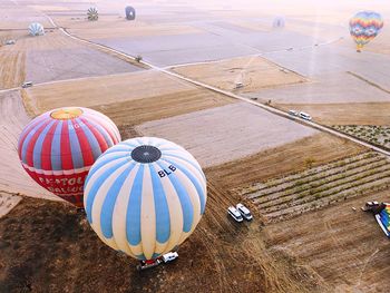 High angle view of hot air balloons on field