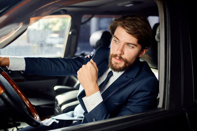 Portrait of man sitting in car