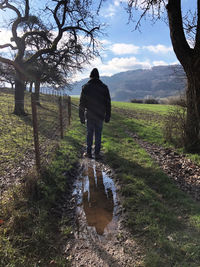 Rear view of man standing on field
