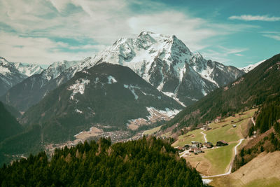 Scenic view of snowcapped mountain against cloudy sky