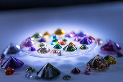 Close-up of multi colored diamonds on table 