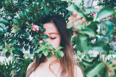 Portrait of woman with pink flowers