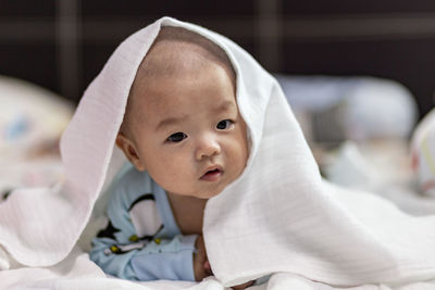 Portrait of cute baby girl on bed