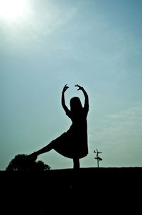 Silhouette of woman against sky