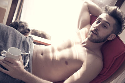 Midsection of man holding camera