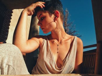 Portrait of young woman sitting outdoors
