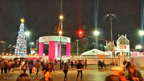 Group of people in amusement park at night