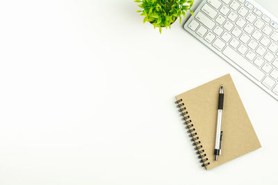 High angle view of book on table against white background