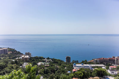 High angle view of townscape by sea against sky