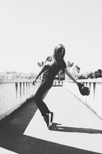 Young woman against clear sky