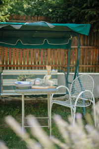 Empty chairs and tables in yard