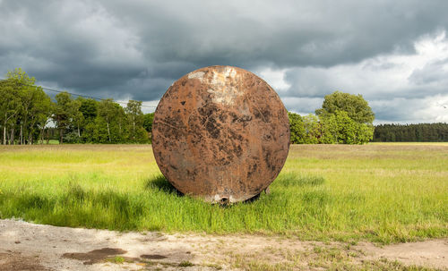 Scenic view of field against cloudy sky