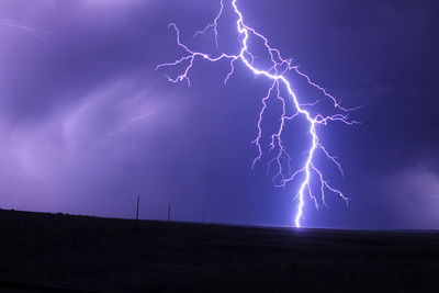 Low angle view of lightning against cloudy sky