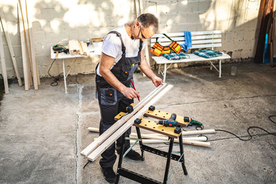 Side view of man working at construction site