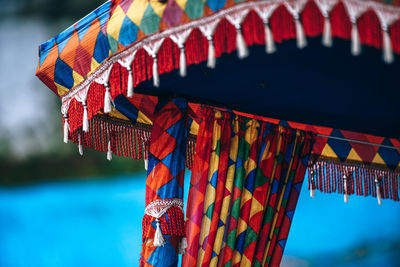 Close-up of multi colored drapes hanging on paddle boat