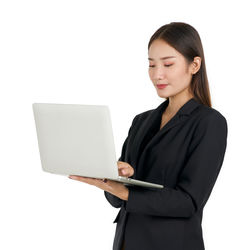 Young woman using mobile phone against white background