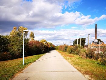 Empty road along landscape and against sky