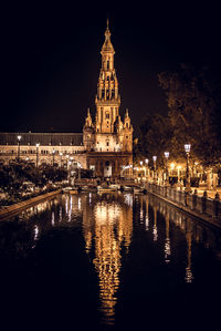 Reflection of illuminated buildings in city at night