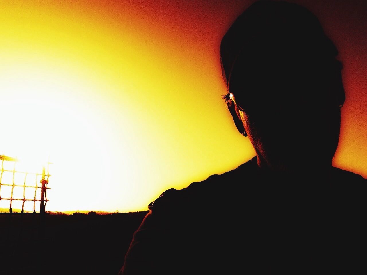 orange color, yellow, copy space, sunset, indoors, wall - building feature, silhouette, close-up, part of, low angle view, lifestyles, built structure, rear view, unrecognizable person, focus on foreground, leisure activity