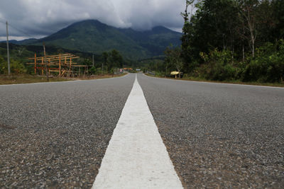 Surface level of empty road against mountain