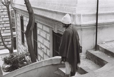 Rear view of man standing by building