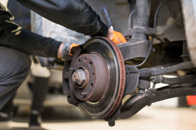 Low angle view of man working on machine