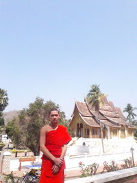 Young man standing against clear sky