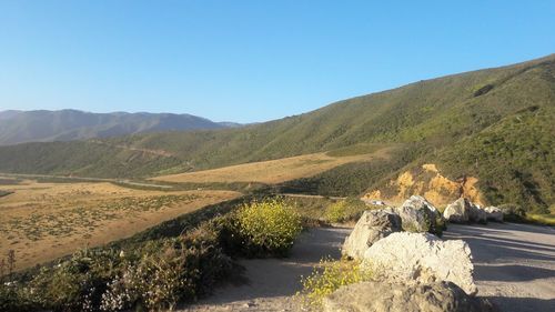 Scenic view of mountains against clear blue sky