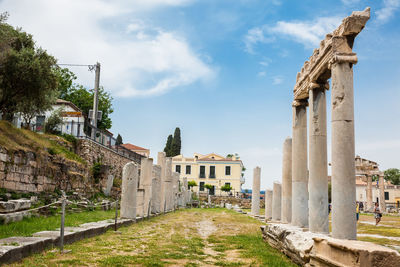 Tourists visiting the ancient ruins at the roman agora in athens