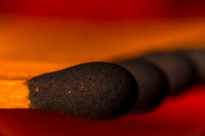 Close-up of matchsticks against red background