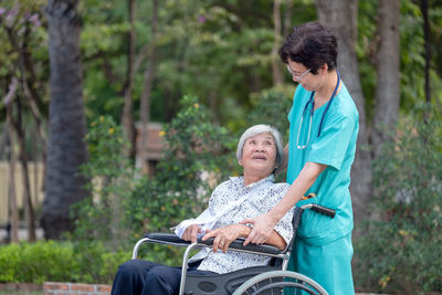 Assistance and care from a doctor asian senior or elderly old lady woman patient in a nursing