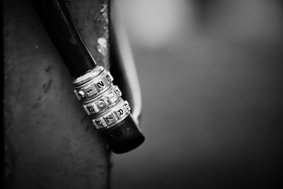 Close-up of telephone pole against wall