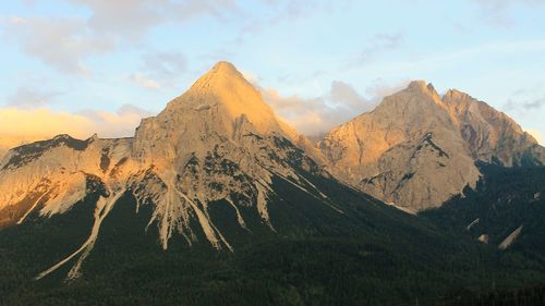 Scenic view of mountains against cloudy sky