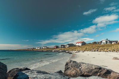 Scenic view of beach against blue sky