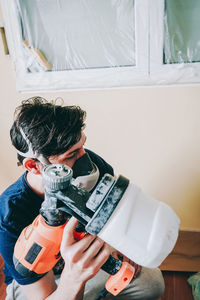 Midsection of boy photographing at home