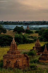 Old buddhist temples against sky during sunset