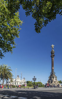 View of city street against blue sky