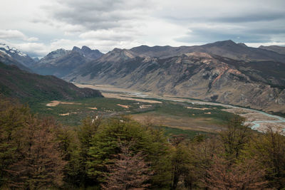 Scenic view of valley mountains against sky in autumn