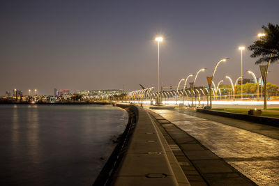 An empty chair along the corniche or the boardwalk overlooking the sea or the bay in doha qatar
