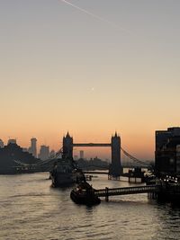 View of bridge over river against sky during sunset