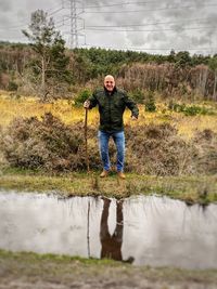 Full length portrait of man standing in water