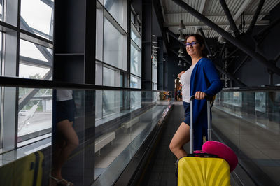 Woman standing on glass window