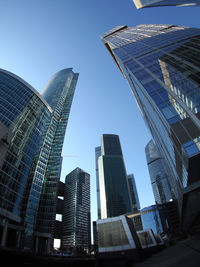 Low angle view of modern building against blue sky