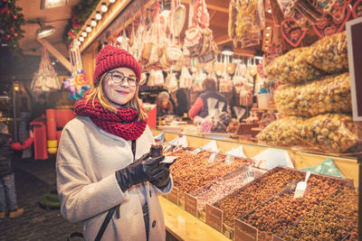 Portrait of woman standing at market stall