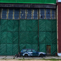 Cars on road by buildings in city