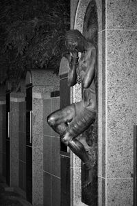 Close-up of statue against metal door